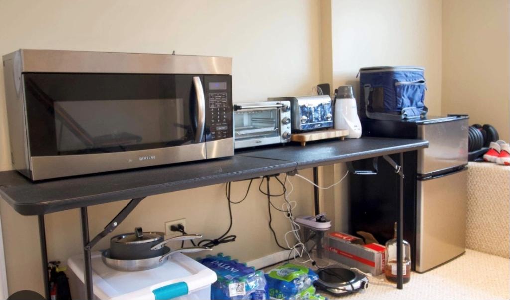 Microwave and toaster oven on a folding shelf as a makeshift kitchen