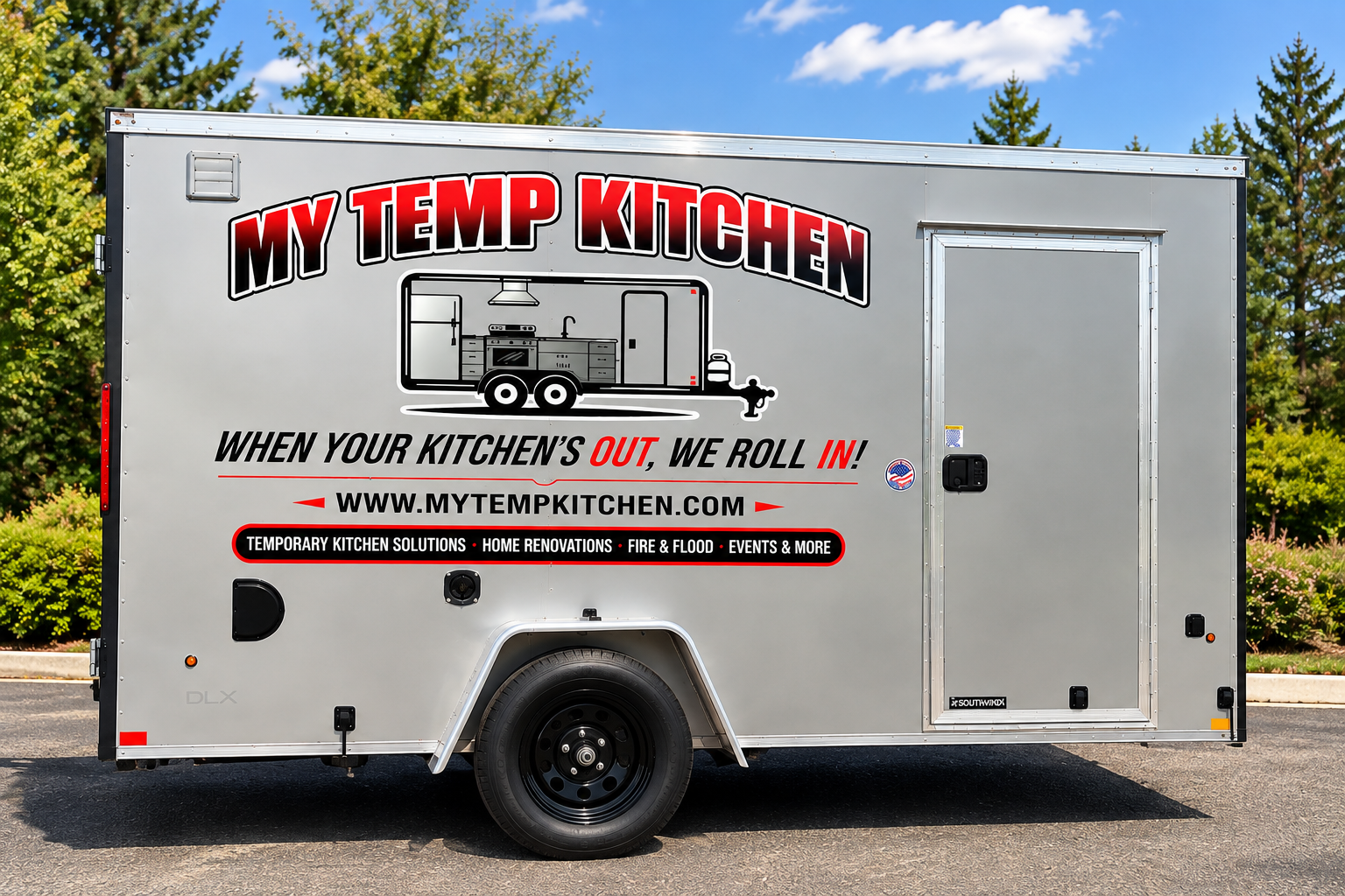 Trailer kitchen showing range, exhaust hood, and marble countertops